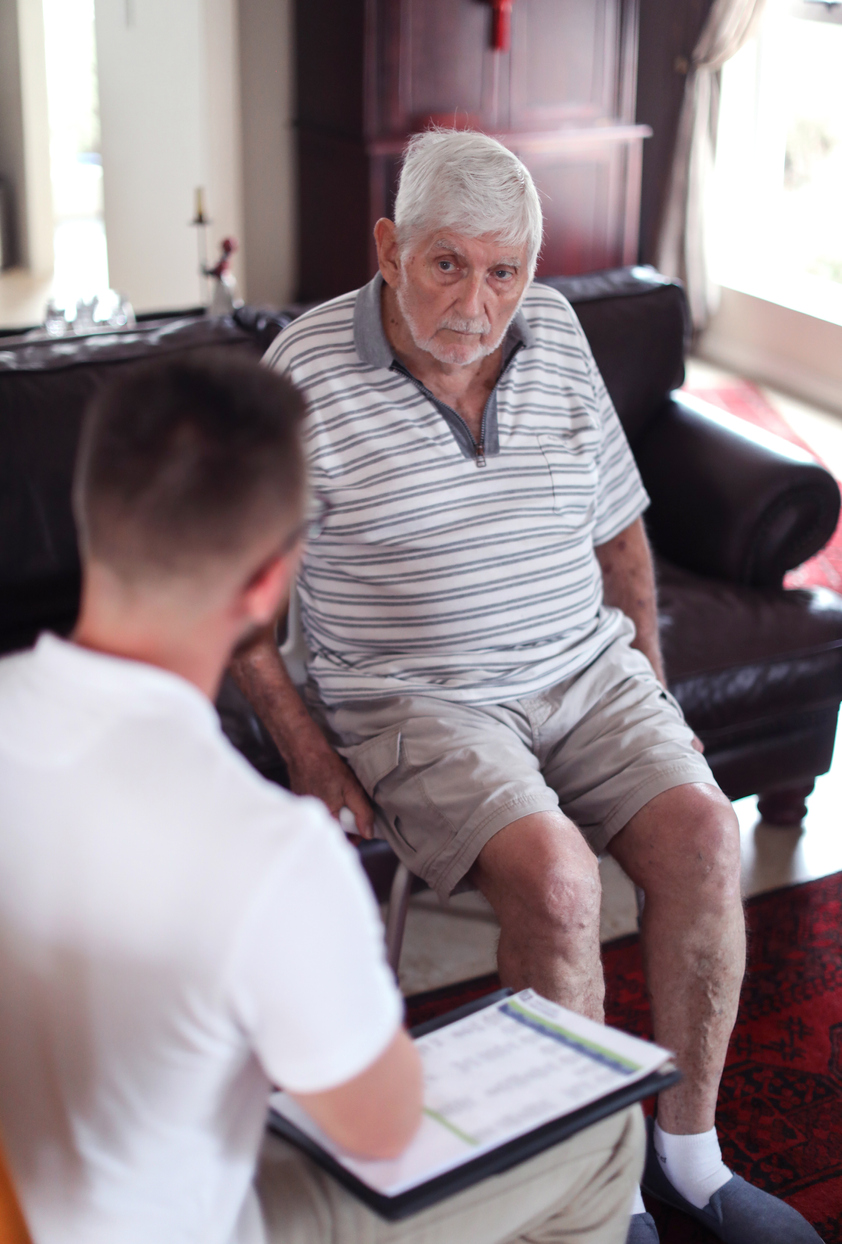 a Senior man receiving physical therapy at home.