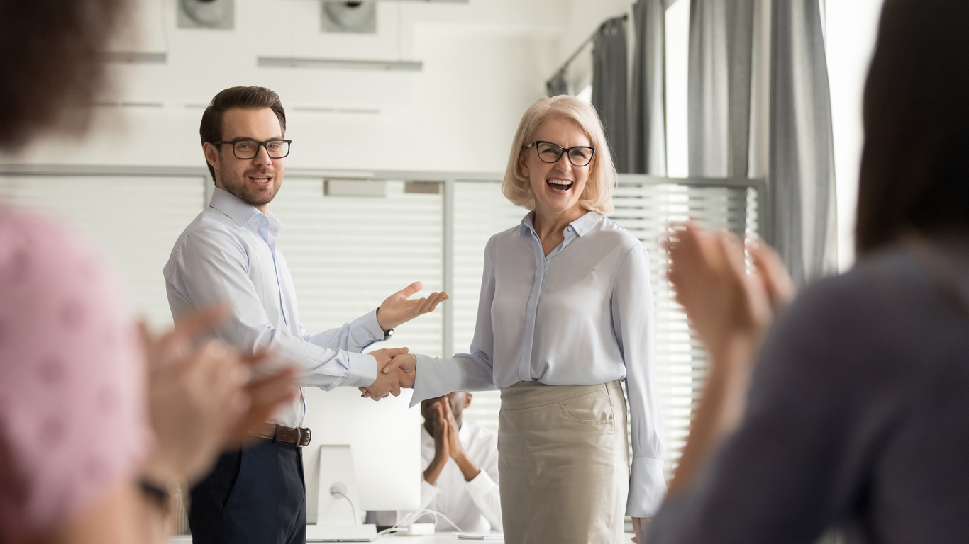 Happy manager boss praising old employee for good work get team appreciation acknowledgement handshaking successful worker congratulating promoting rewarding welcoming new partner, respect handshake