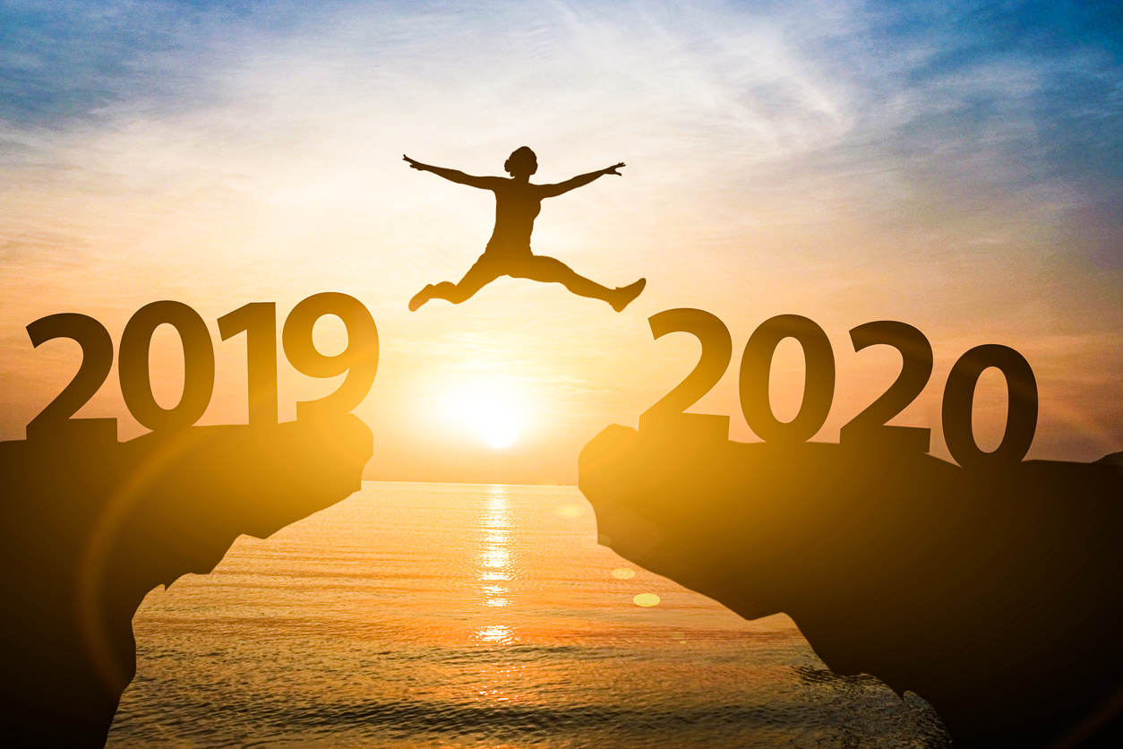 Man jump from year 2019 to 2020. Starting of new year concept.