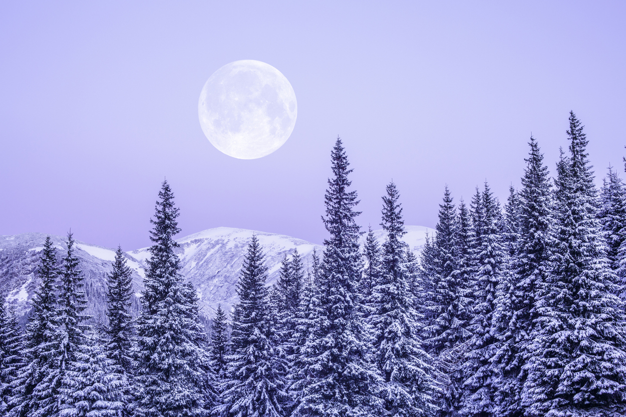 Moonrise in snowy mountains