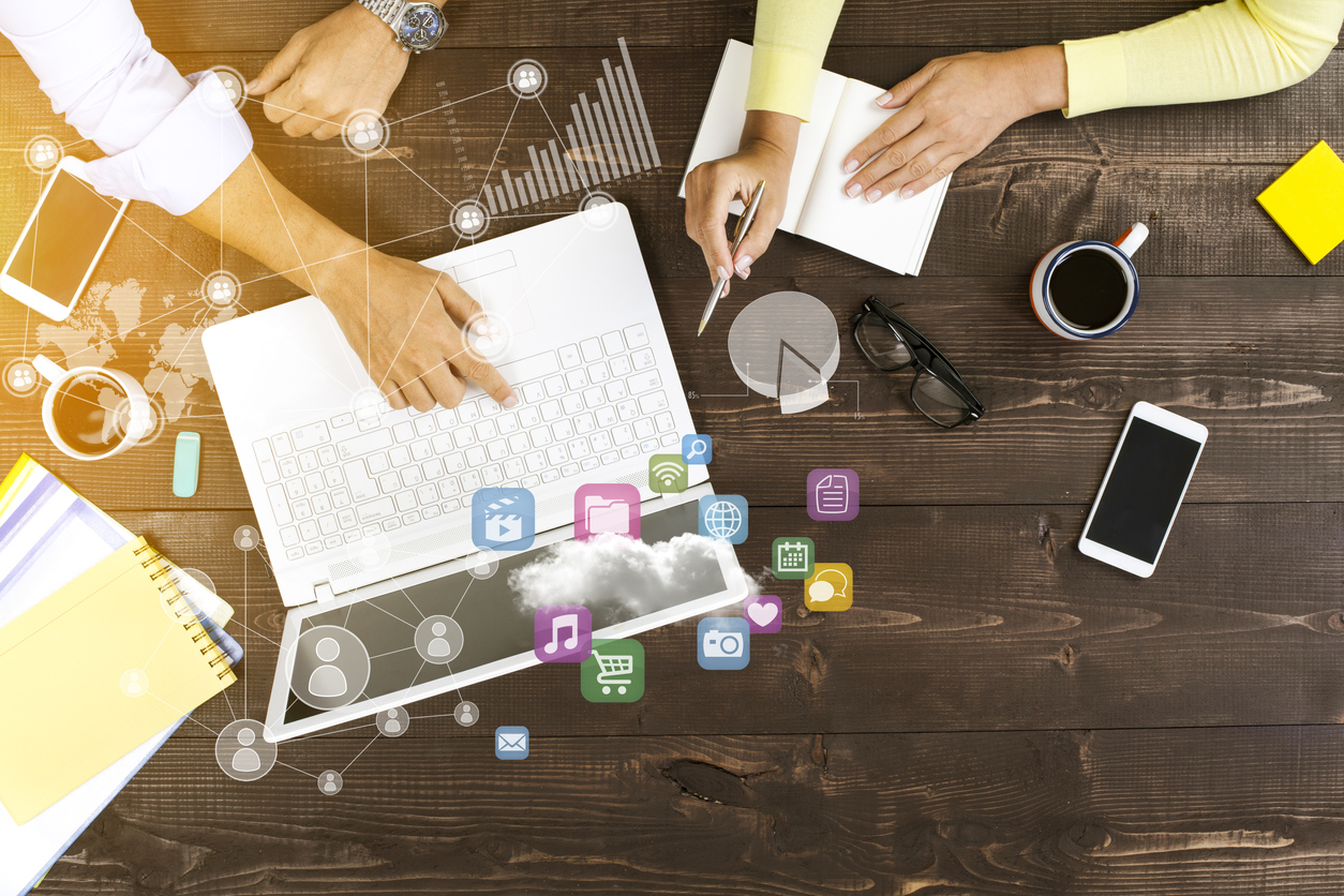 Two people working together on laptop at office with technological pattern
